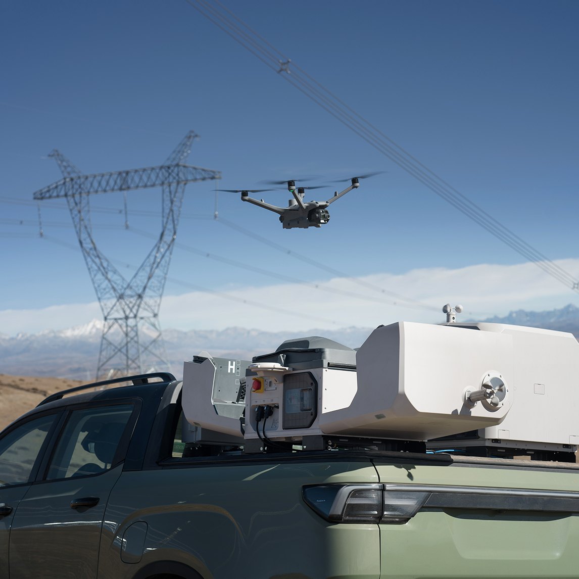 DJI Dock 3 mounted on a pickup truck with drone in flight